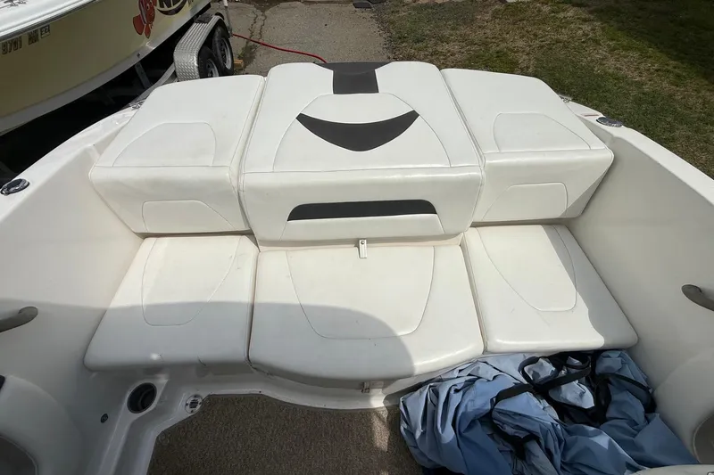 Slide: The Image of 2012 Chaparral 18 H2O Sport boat interior with white cushioned seating. - 16