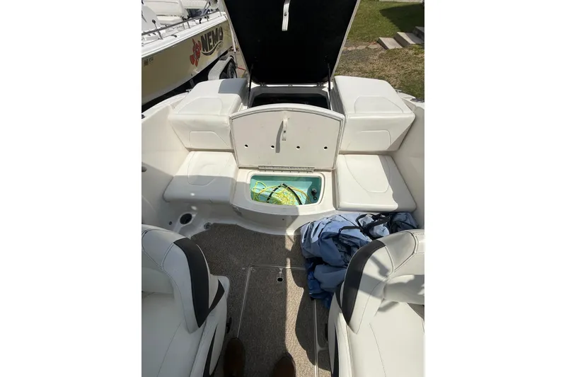 Slide: The Image of 2012 Chaparral 18 H2O Sport boat interior with open storage compartment. - 19