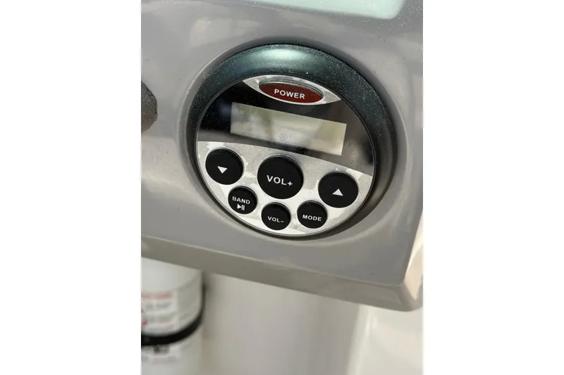 Slide: The Image of Control panel of a 2012 Chaparral 18 H2O Sport boat, featuring power and volume buttons. - 22