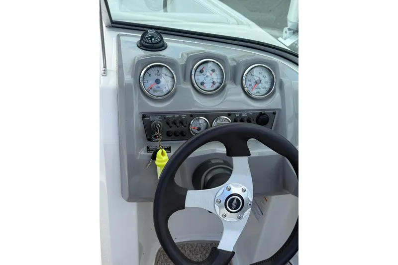 Slide: The Image of Steering console of a 2012 Chaparral 18 H2O Sport boat with gauges and controls. - 24