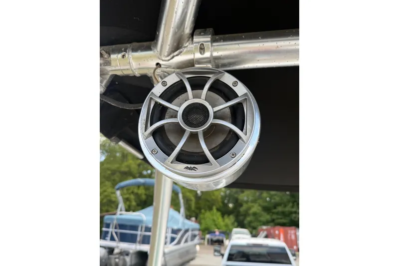 Slide: The Image of Speaker mounted on a 2012 Chaparral 18 H2O Sport boat, with background boats visible. - 25