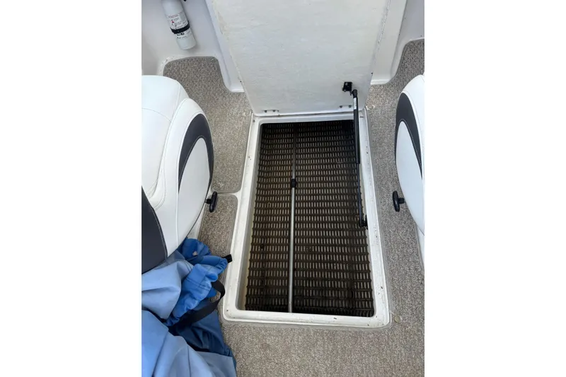 Slide: The Image of Interior view of a 2012 Chaparral 18 H2O Sport boat showing storage compartment. - 26