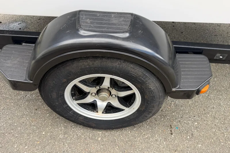 Slide: The Image of Trailer wheel and fender of a 2012 Chaparral 18 H2O Sport boat. - 28