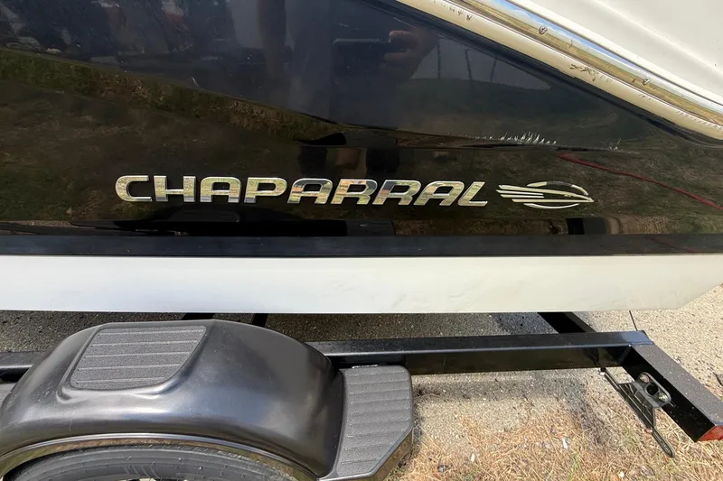 Slide: The Image of 2012 Chaparral 18 H2O Sport boat on trailer, featuring sleek black and white design. - 3