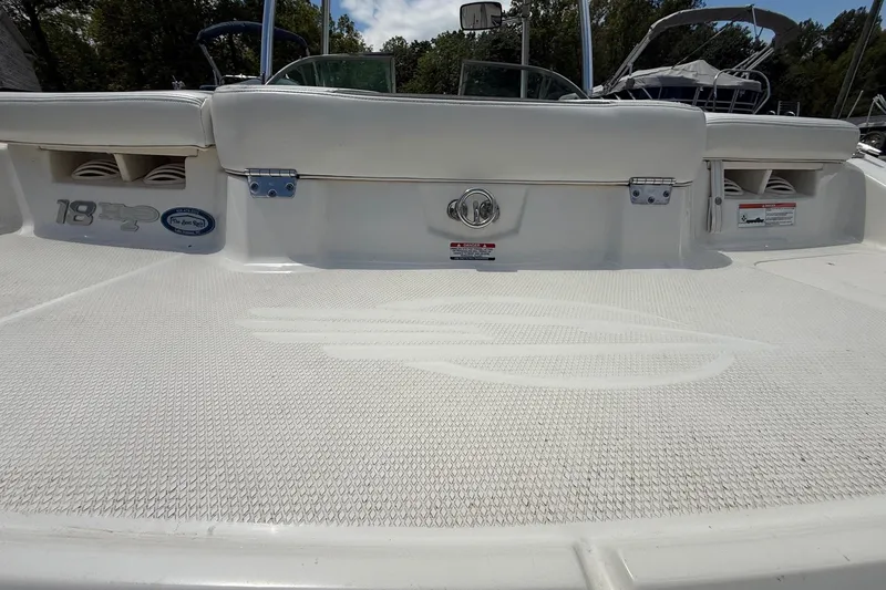 Slide: The Image of 2012 Chaparral 18 H2O Sport boat deck with logo and storage compartments. - 7