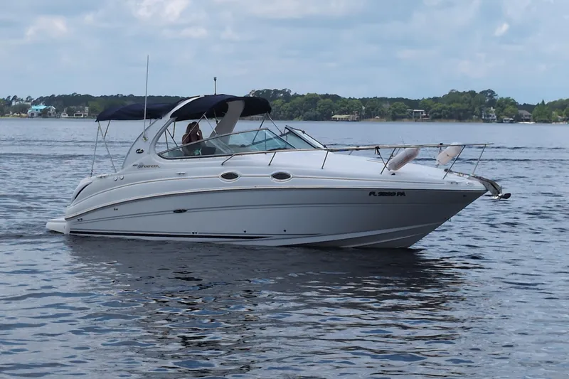 The Image of 2005 Sea Ray Sundancer 280 cruising on a calm lake under a cloudy sky. - 0