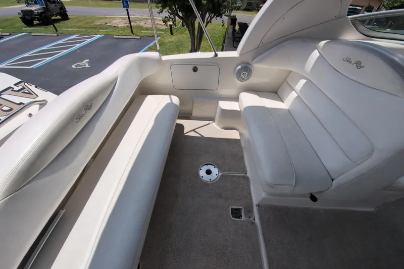Slide: The Image of 2005 Sea Ray Sundancer 280 boat interior with white seating and carpeted floor. - 15
