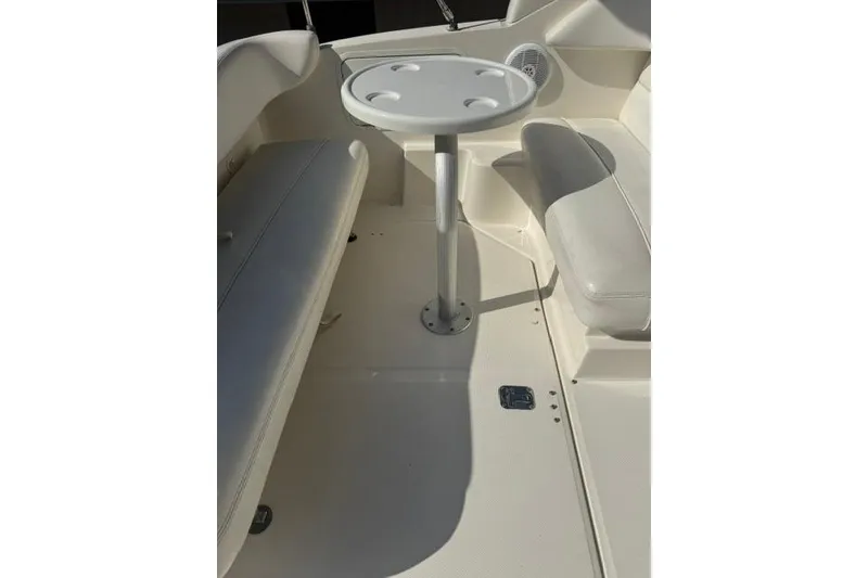 Slide: The Image of 2005 Sea Ray Sundancer 280 interior with seating and table setup. - 16
