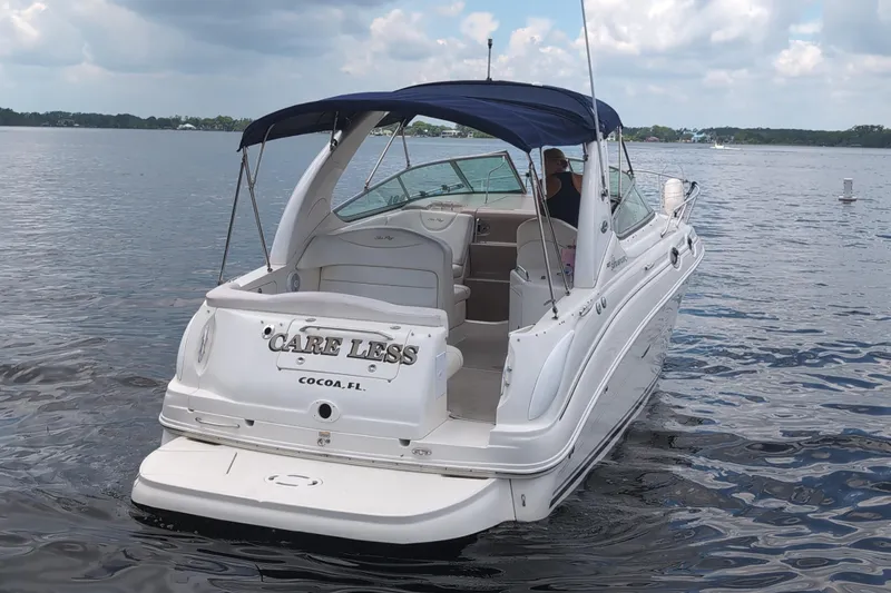 Slide: The Image of 2005 Sea Ray Sundancer 280 boat on water, featuring "Care Less" name and Cocoa, FL location. - 2