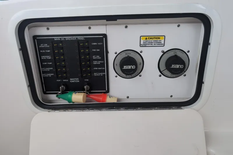 Slide: The Image of Control panel of a 2005 Sea Ray Sundancer 280 boat with breaker switches and caution label. - 20