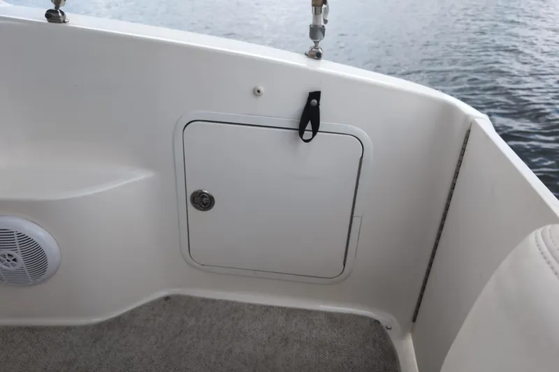 Slide: The Image of 2005 Sea Ray Sundancer 280 boat interior with storage compartment and speaker. - 21