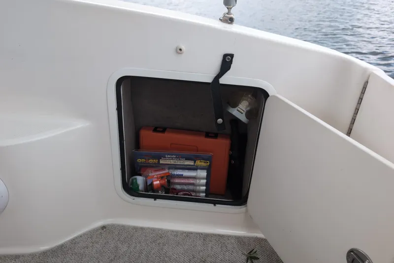 Slide: The Image of Storage compartment on a 2005 Sea Ray Sundancer 280 boat with safety equipment. - 22