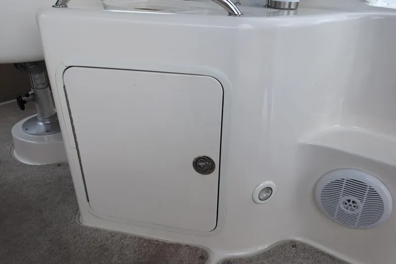 Slide: The Image of 2005 Sea Ray Sundancer 280 interior detail with storage compartment and speaker. - 23