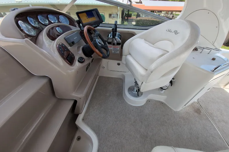Slide: The Image of 2005 Sea Ray Sundancer 280 helm with steering wheel, gauges, and captain's chair. - 26