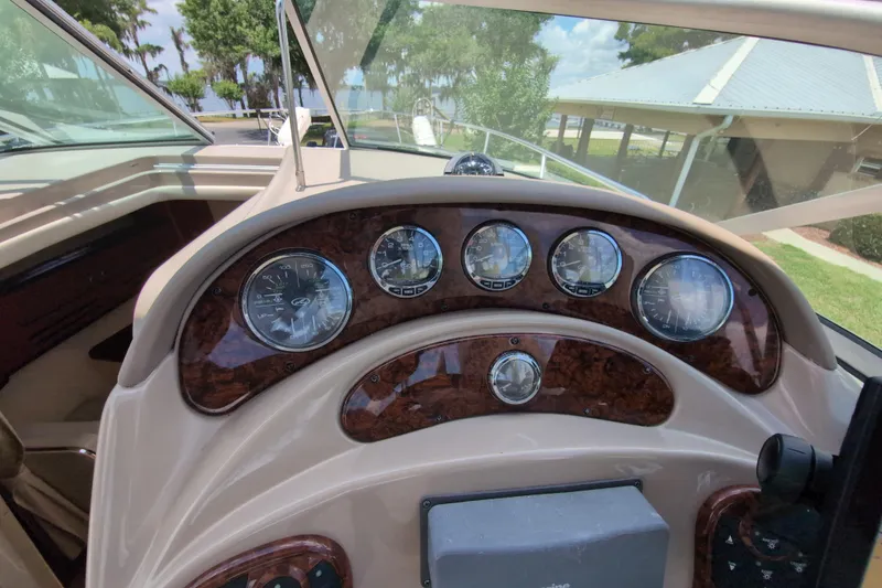 Slide: The Image of Dashboard of a 2005 Sea Ray Sundancer 280 boat with gauges and controls. - 28