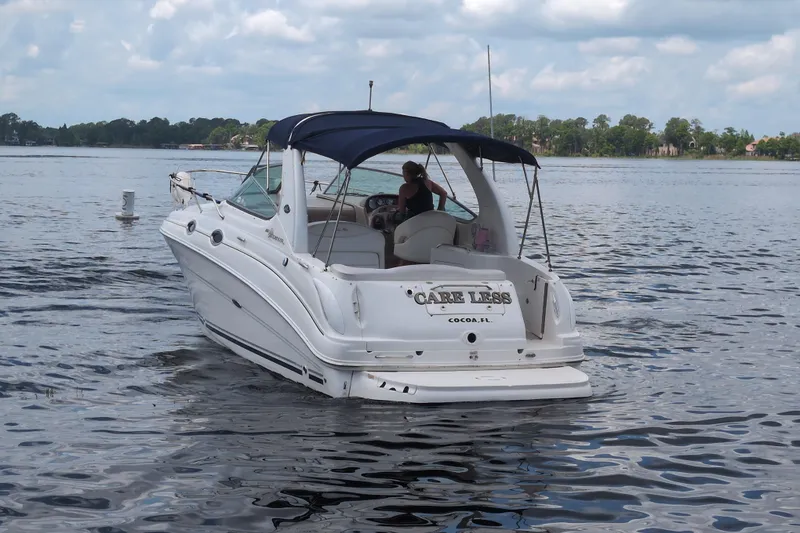 Slide: The Image of 2005 Sea Ray Sundancer 280 boat on calm water, featuring a blue canopy. - 3