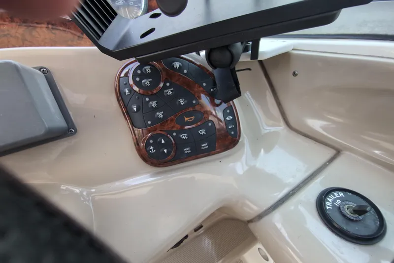 Slide: The Image of Control panel of a 2005 Sea Ray Sundancer 280 boat with various switches. - 30