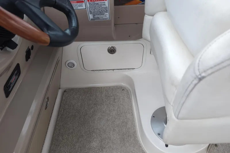 Slide: The Image of Interior of a 2005 Sea Ray Sundancer 280 boat, featuring steering wheel and seating area. - 31