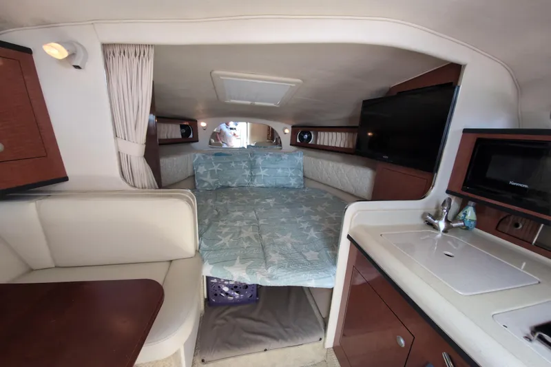 Slide: The Image of Interior of 2005 Sea Ray Sundancer 280 with bed, kitchenette, and seating area. - 36