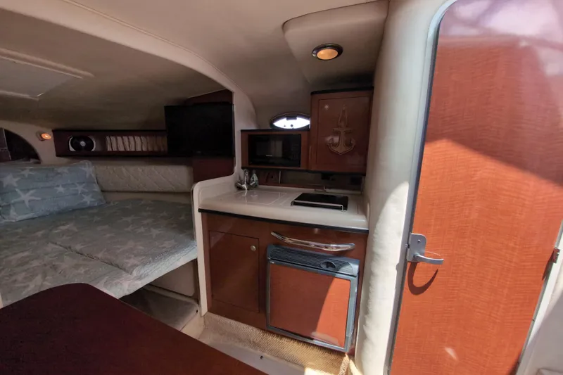 Slide: The Image of Interior of 2005 Sea Ray Sundancer 280 with kitchenette and cozy sleeping area. - 39