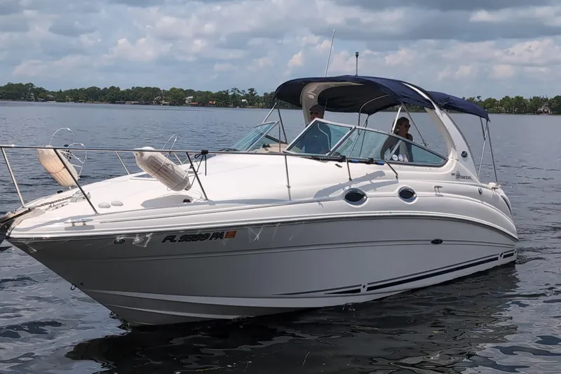 Slide: The Image of 2005 Sea Ray Sundancer 280 cruising on a calm lake under a cloudy sky. - 4