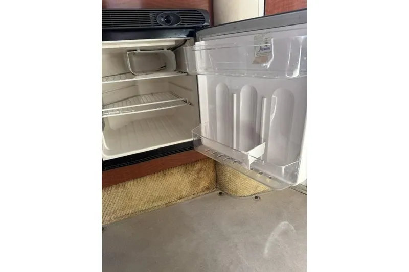 Slide: The Image of Open refrigerator inside a 2005 Sea Ray Sundancer 280 boat cabin. - 42