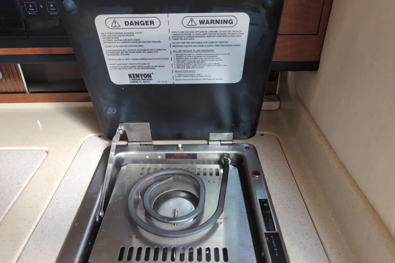 Slide: The Image of Kenyon stove in 2005 Sea Ray Sundancer 280 boat kitchen, with safety warnings displayed. - 45