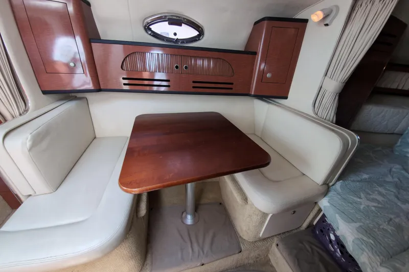 Slide: The Image of Interior of 2005 Sea Ray Sundancer 280 with cozy dining area and wooden table. - 46