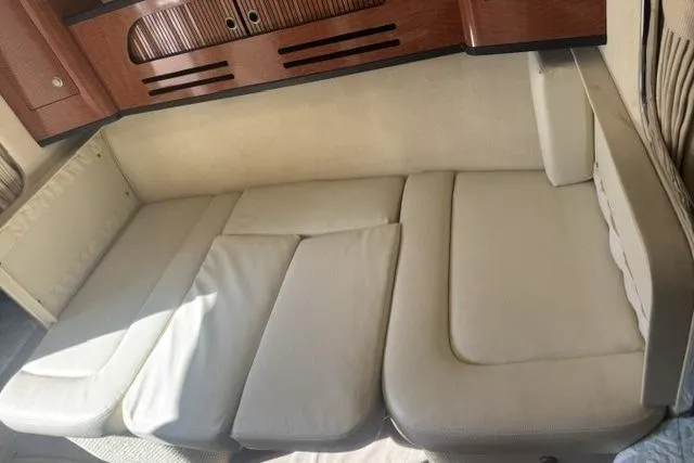 Slide: The Image of Interior seating of 2005 Sea Ray Sundancer 280 with beige cushions and wooden accents. - 47