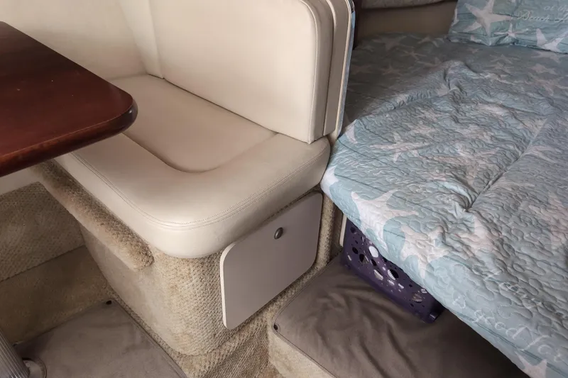Slide: The Image of Interior of 2005 Sea Ray Sundancer 280 with seating and star-patterned bedding. - 50