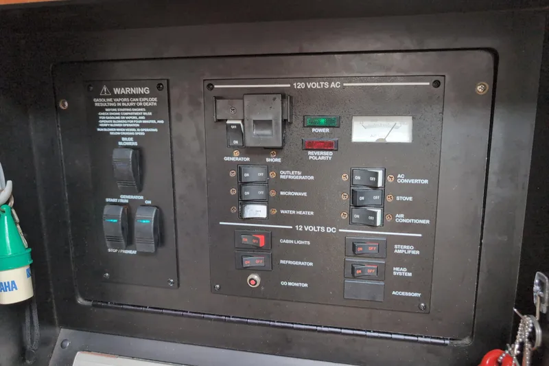 Slide: The Image of Control panel of a 2005 Sea Ray Sundancer 280 boat, featuring various switches and warnings. - 53