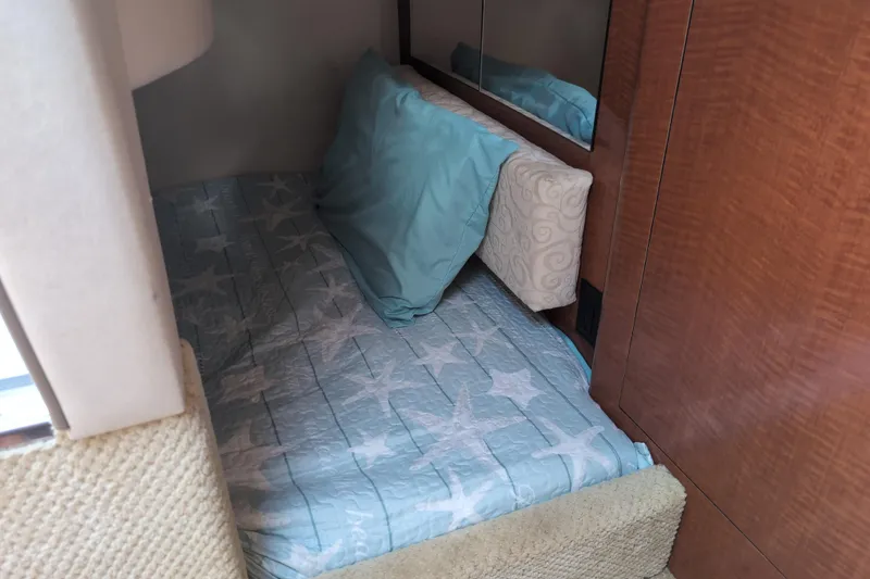 Slide: The Image of Interior cabin bed of 2005 Sea Ray Sundancer 280 with star-patterned bedding. - 58