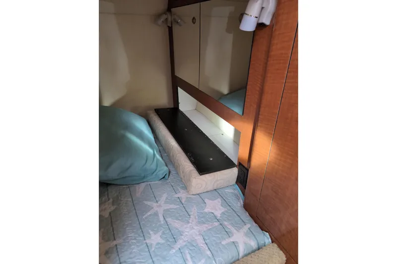Slide: The Image of Interior cabin of 2005 Sea Ray Sundancer 280 with bedding and mirror. - 59