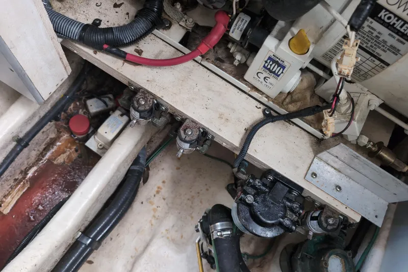 Slide: The Image of Engine compartment of a 2005 Sea Ray Sundancer 280, showing mechanical components and wiring. - 70