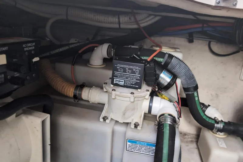 Slide: The Image of Engine compartment of a 2005 Sea Ray Sundancer 280, showcasing marine sanitation hardware. - 72