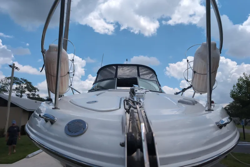 Slide: The Image of 2005 Sea Ray Sundancer 280 boat under a cloudy sky, showcasing its sleek design. - 8