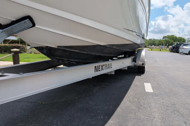 Slide: The Image of 2005 Sea Ray Sundancer 280 on a Next Trail trailer, parked on asphalt under a blue sky. - 82