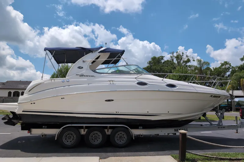 Slide: The Image of 2005 Sea Ray Sundancer 280 boat on trailer under blue sky. - 83