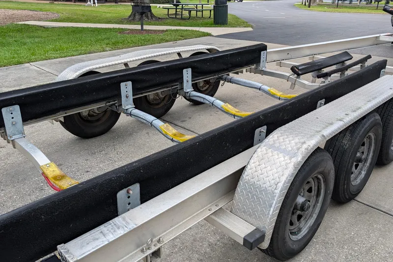 Slide: The Image of Boat trailer for 2005 Sea Ray Sundancer 280, parked on concrete with green grass nearby. - 89