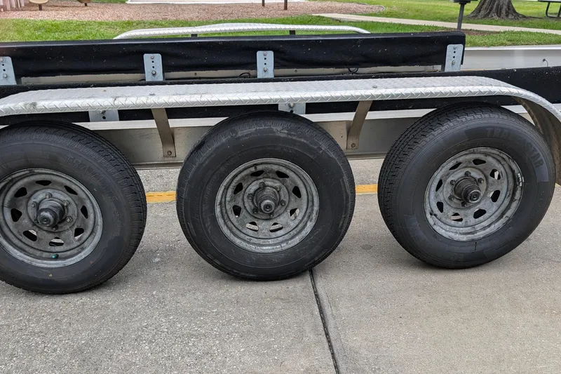 Slide: The Image of Triple-axle trailer for 2005 Sea Ray Sundancer 280 boat on pavement. - 90