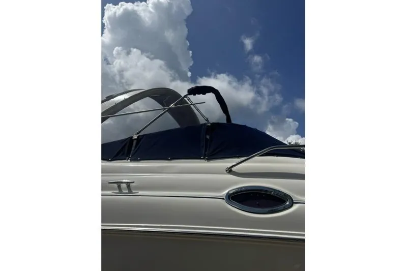 Slide: The Image of 2005 Sea Ray Sundancer 280 boat under a cloudy sky. - 94
