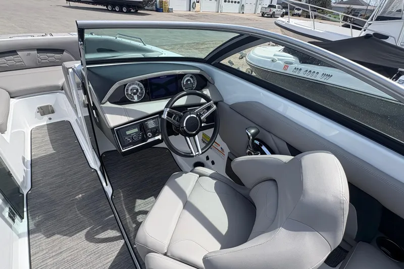 Slide: The Image of 2023 Four Winns HD3 boat interior with modern dashboard and comfortable seating. - 16