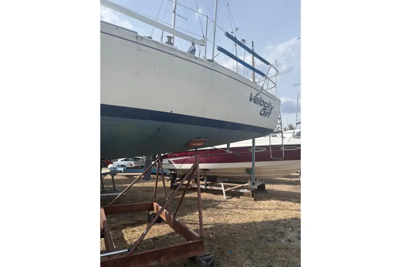 Slide: The Image of 1976 J Boats J/29 sailboat "Velocity Girl" on dry dock, side view. - 3