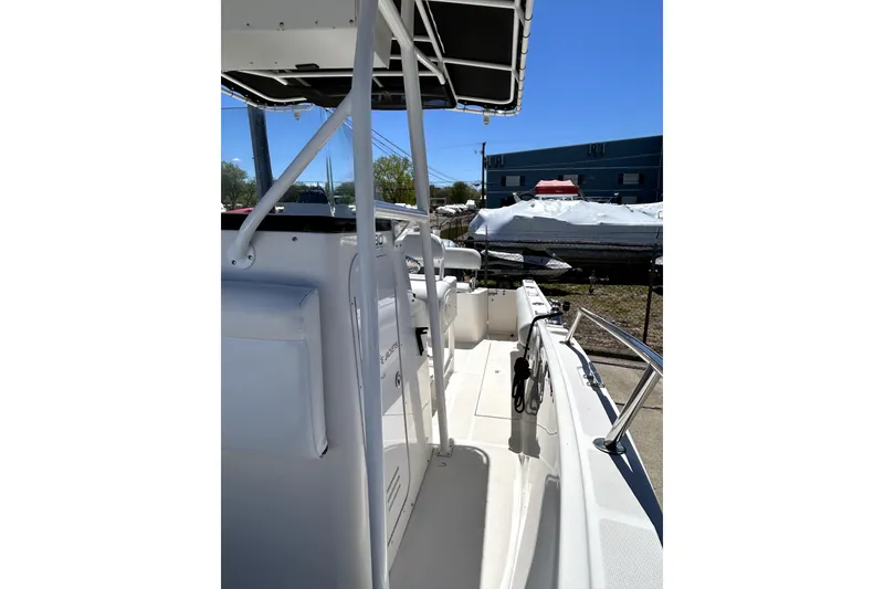 Slide: The Image of 2004 Robalo R230 Center Console boat with T-top, docked outdoors. - 10