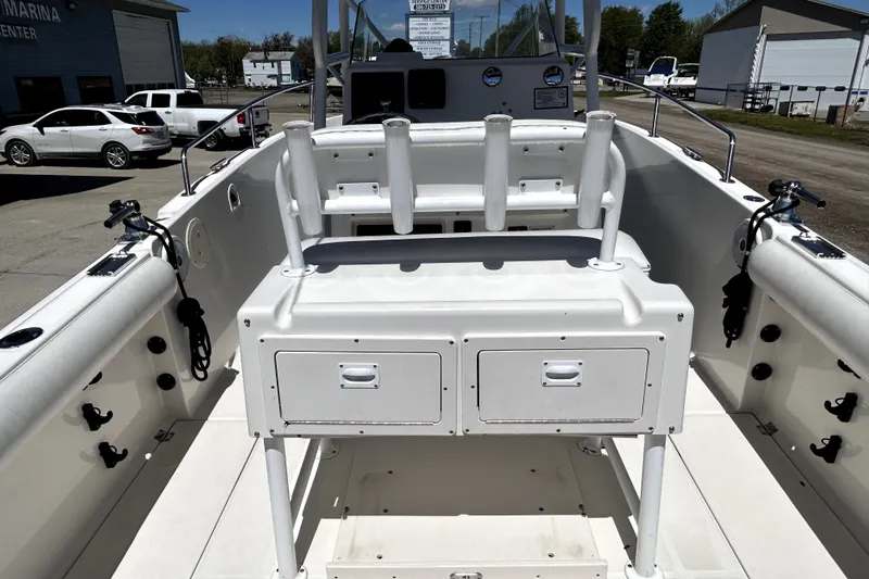 Slide: The Image of 2004 Robalo R230 Center Console boat interior with rod holders and storage compartments. - 15