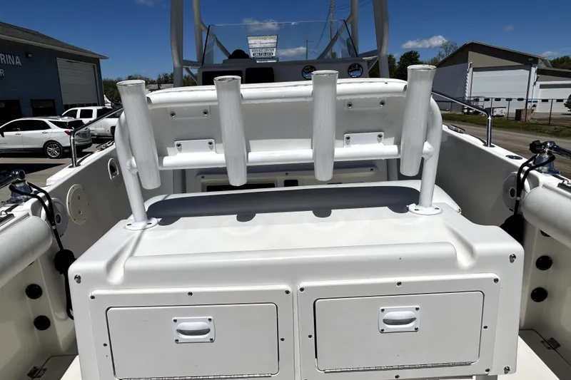 Slide: The Image of 2004 Robalo R230 Center Console boat interior with rod holders and storage compartments. - 16