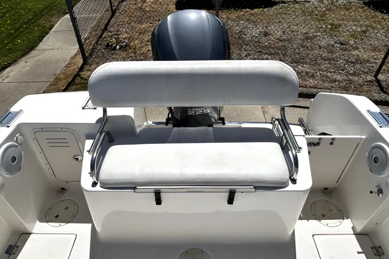 Slide: The Image of 2004 Robalo R230 Center Console boat with Yamaha engine, featuring a cushioned bench seat. - 17
