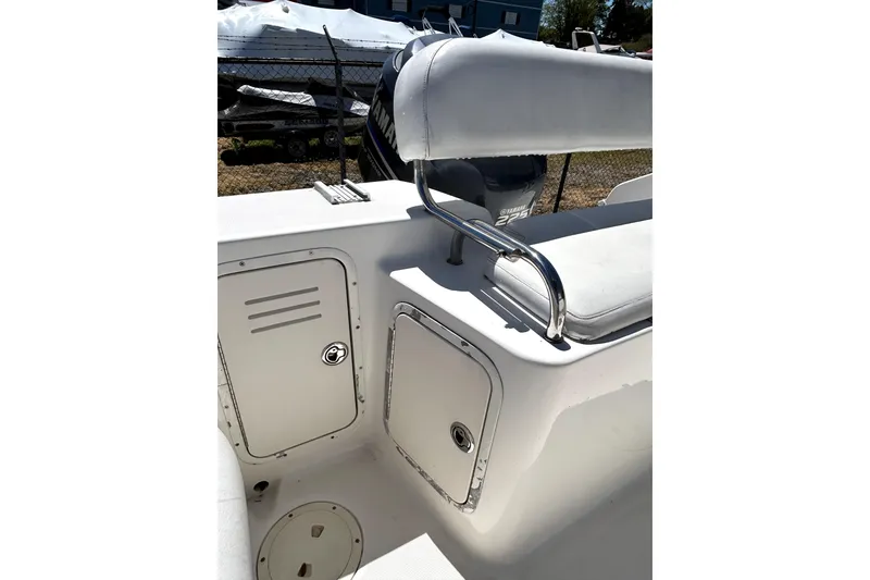 Slide: The Image of 2004 Robalo R230 Center Console boat interior with storage compartments and seating. - 19