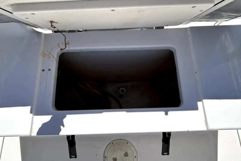 Slide: The Image of Open storage compartment on a 2004 Robalo R230 Center Console boat. - 20