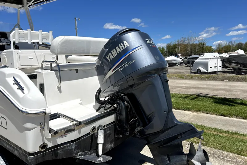 Slide: The Image of 2004 Robalo R230 Center Console boat with Yamaha 225 outboard motor, parked outdoors. - 3